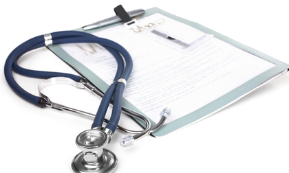 Stethoscope and a notepad isolated over white background