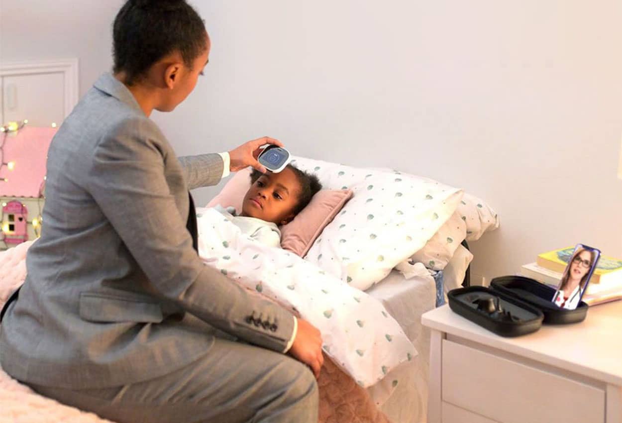 Patient in bed using TytoCare