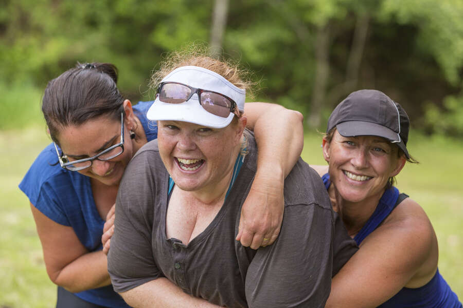 Hugging mature aged women hugging each other after completing a fun run together