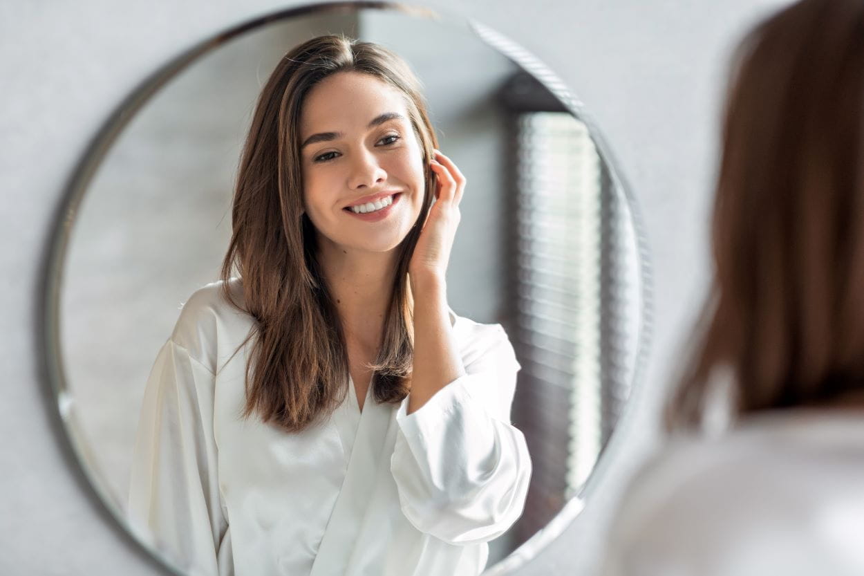 woman looking in mirror