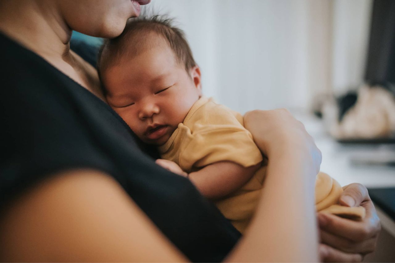 Woman holding a sleeping baby