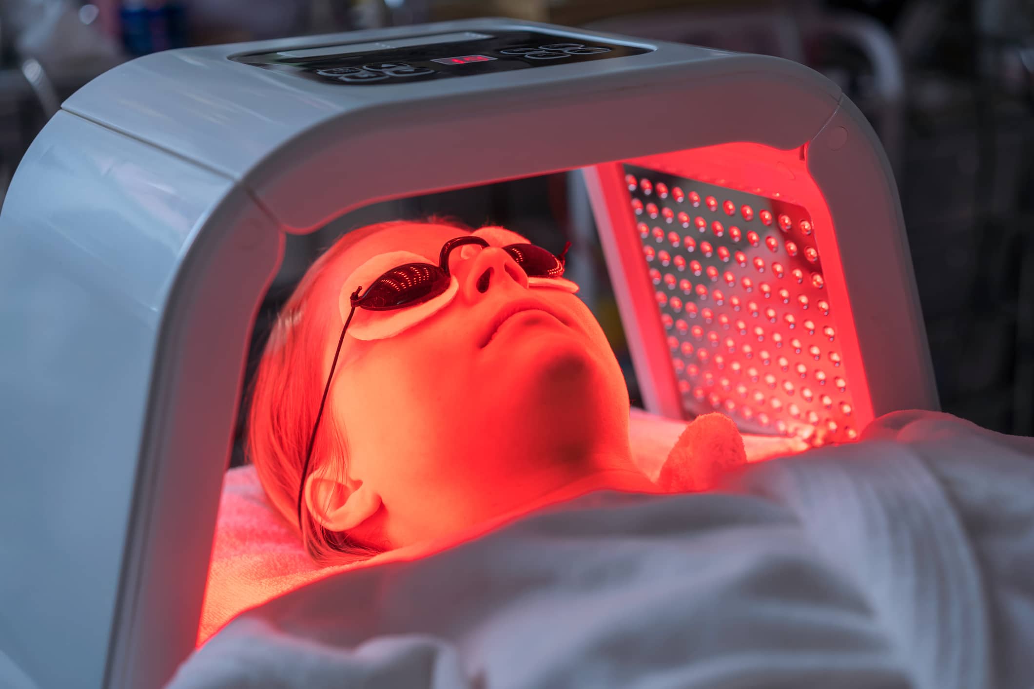 Woman Under a Red Light Mask