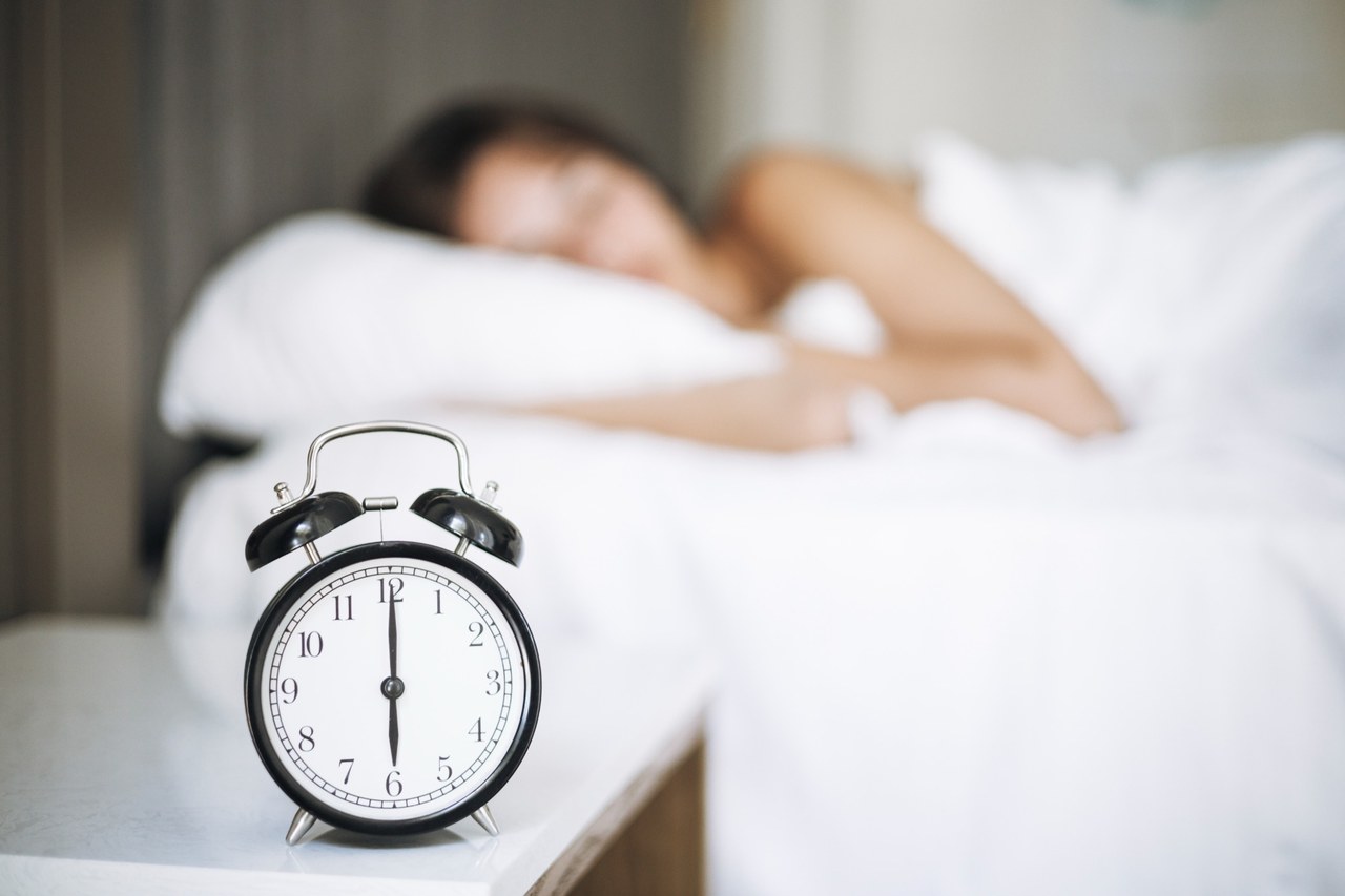 Alarm clock and woman sleeping