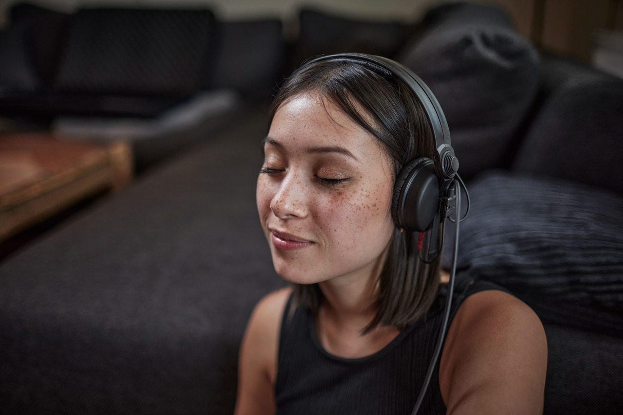 Woman, eyes closed, listening to music