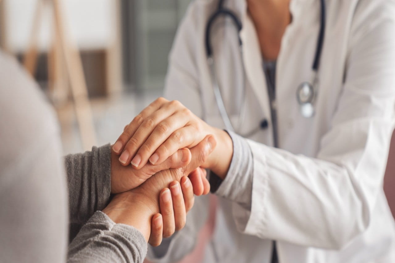 Doctor holding a patient's hand