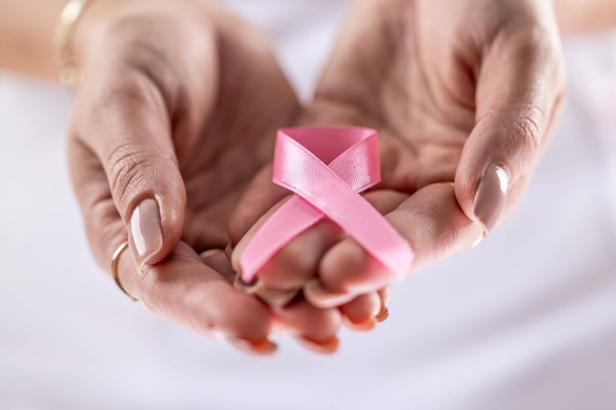 Pink Ribbon in Cupped Hands