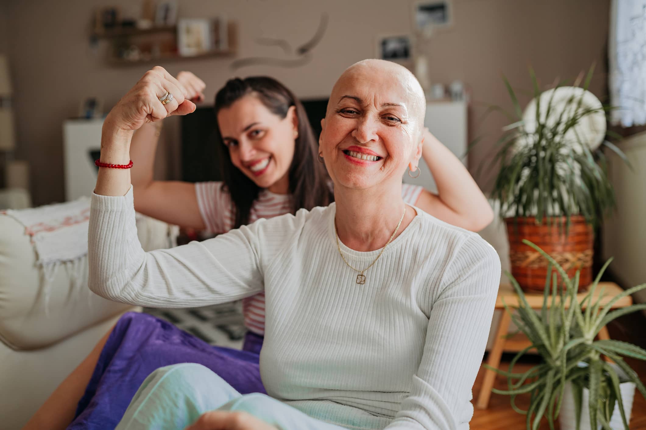 Two women showing off muscles