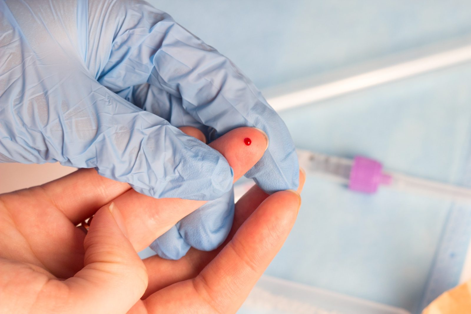 Fingerstick blood drop.