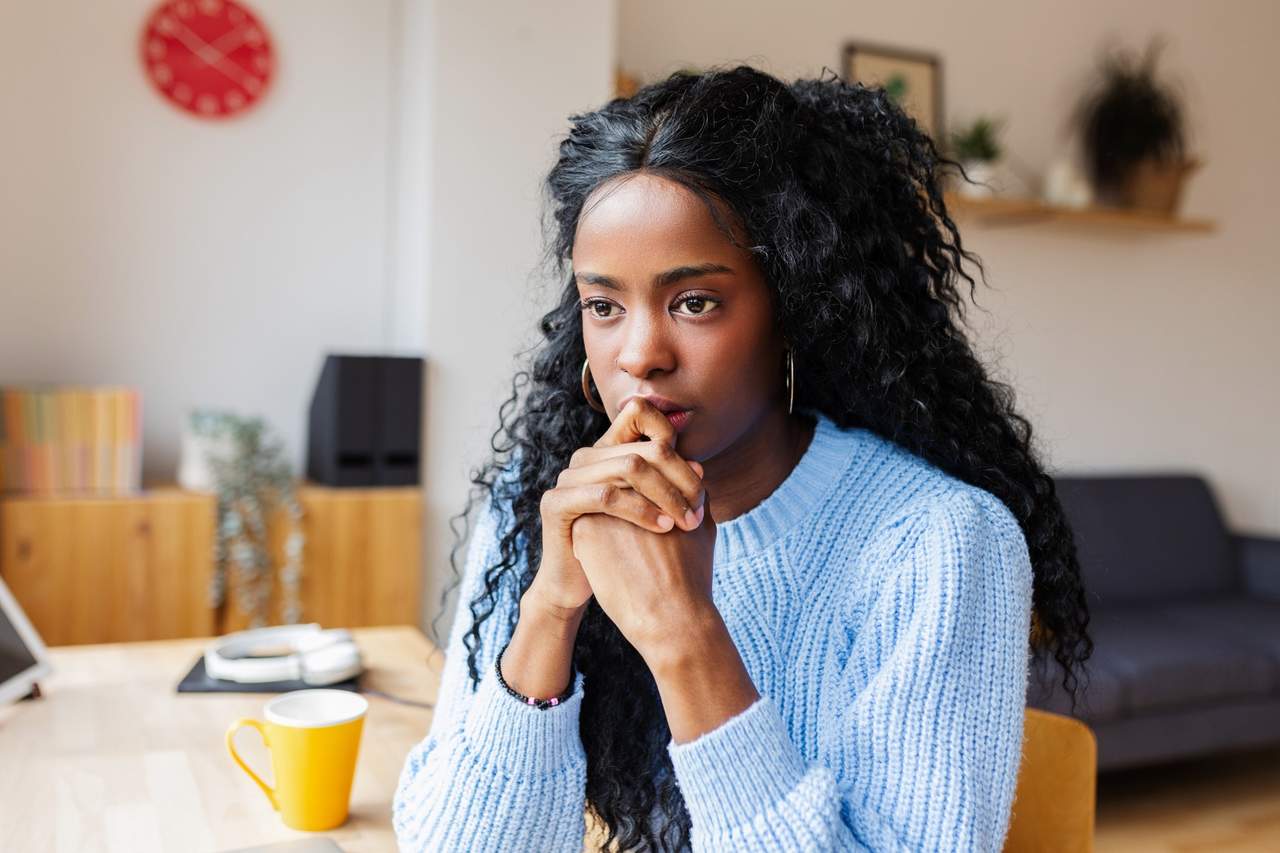 Woman thinking at home