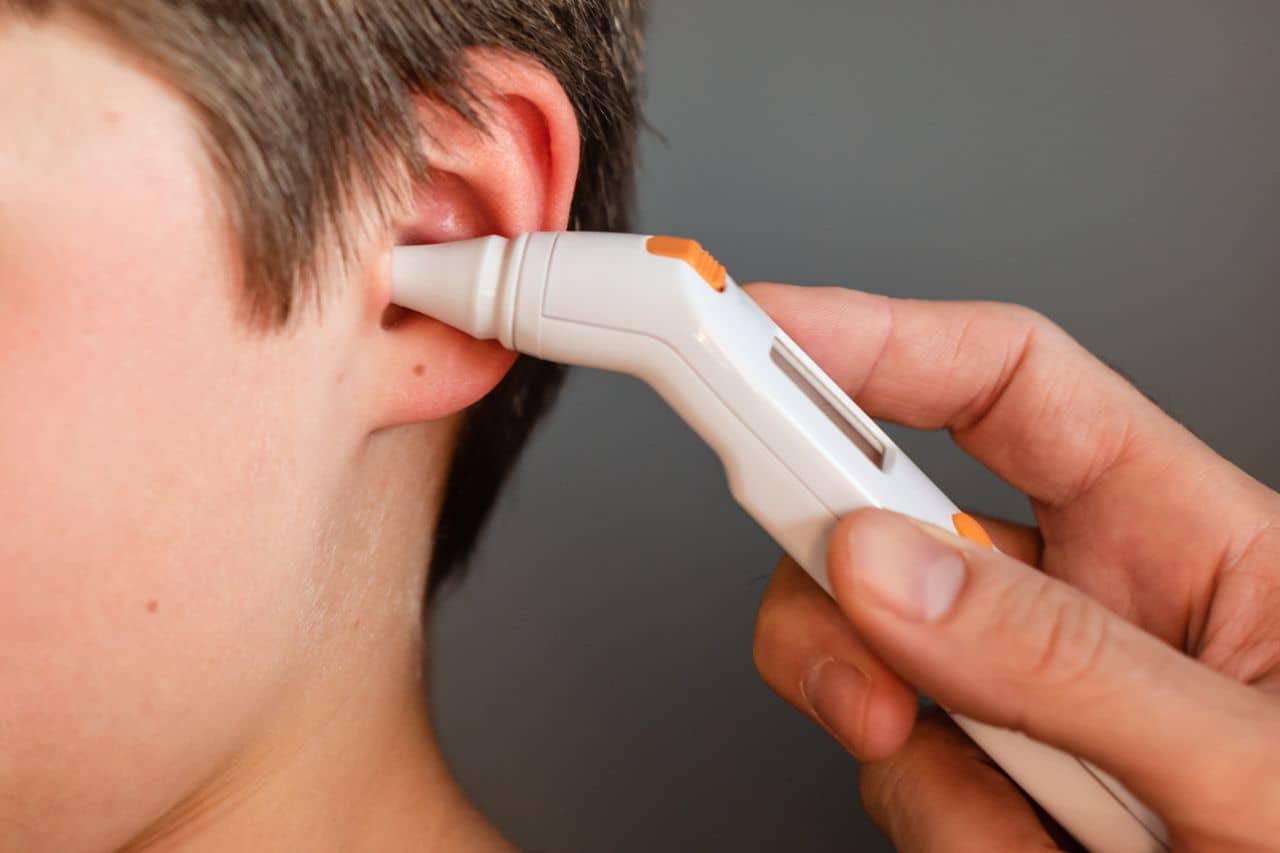 Doctor checking a kid's ear