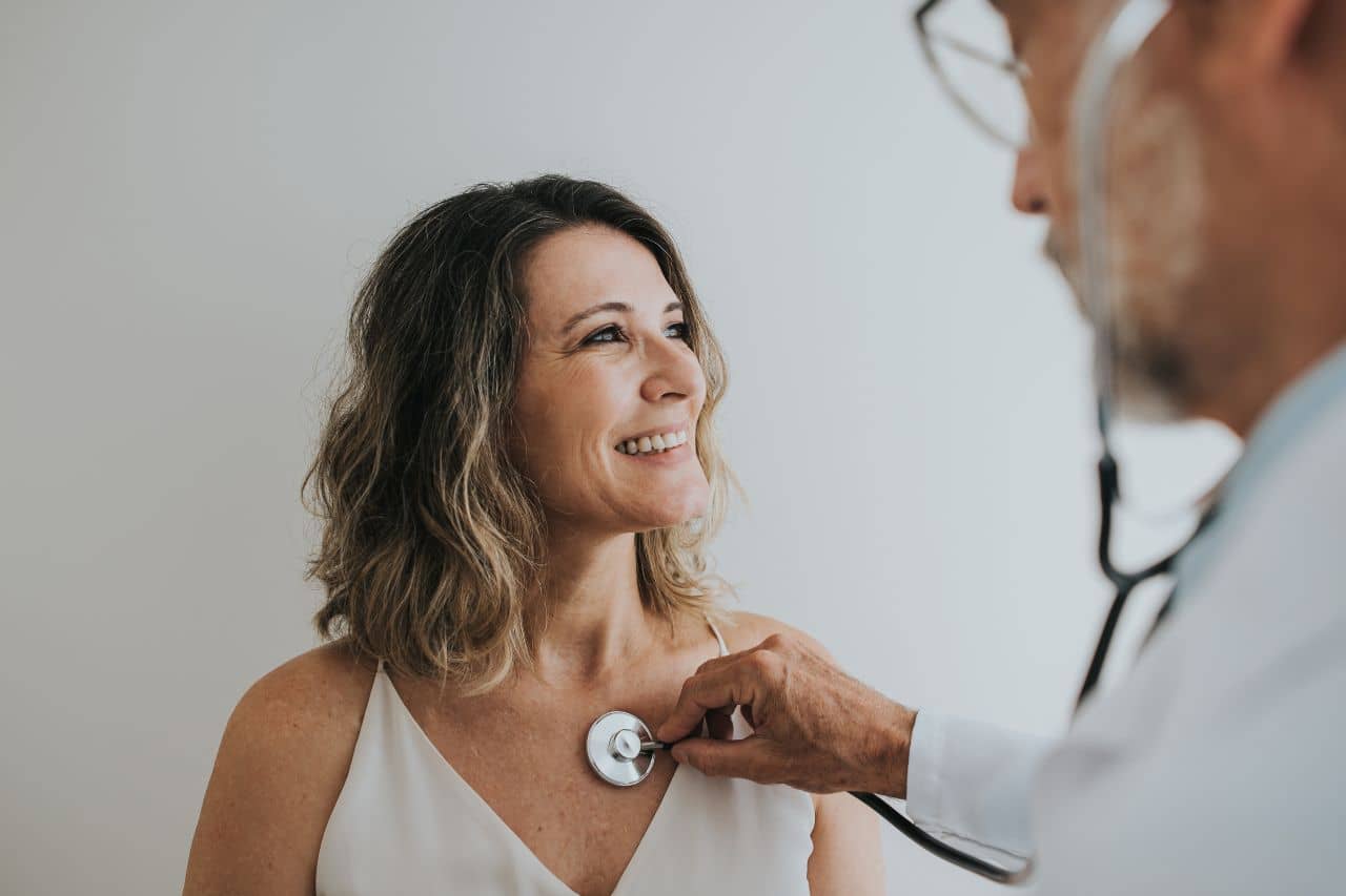 Doctor checking a woman's heart