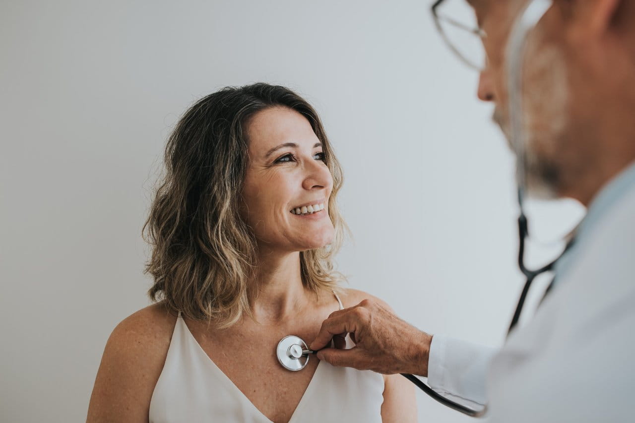 Doctor checking the heart of a patient