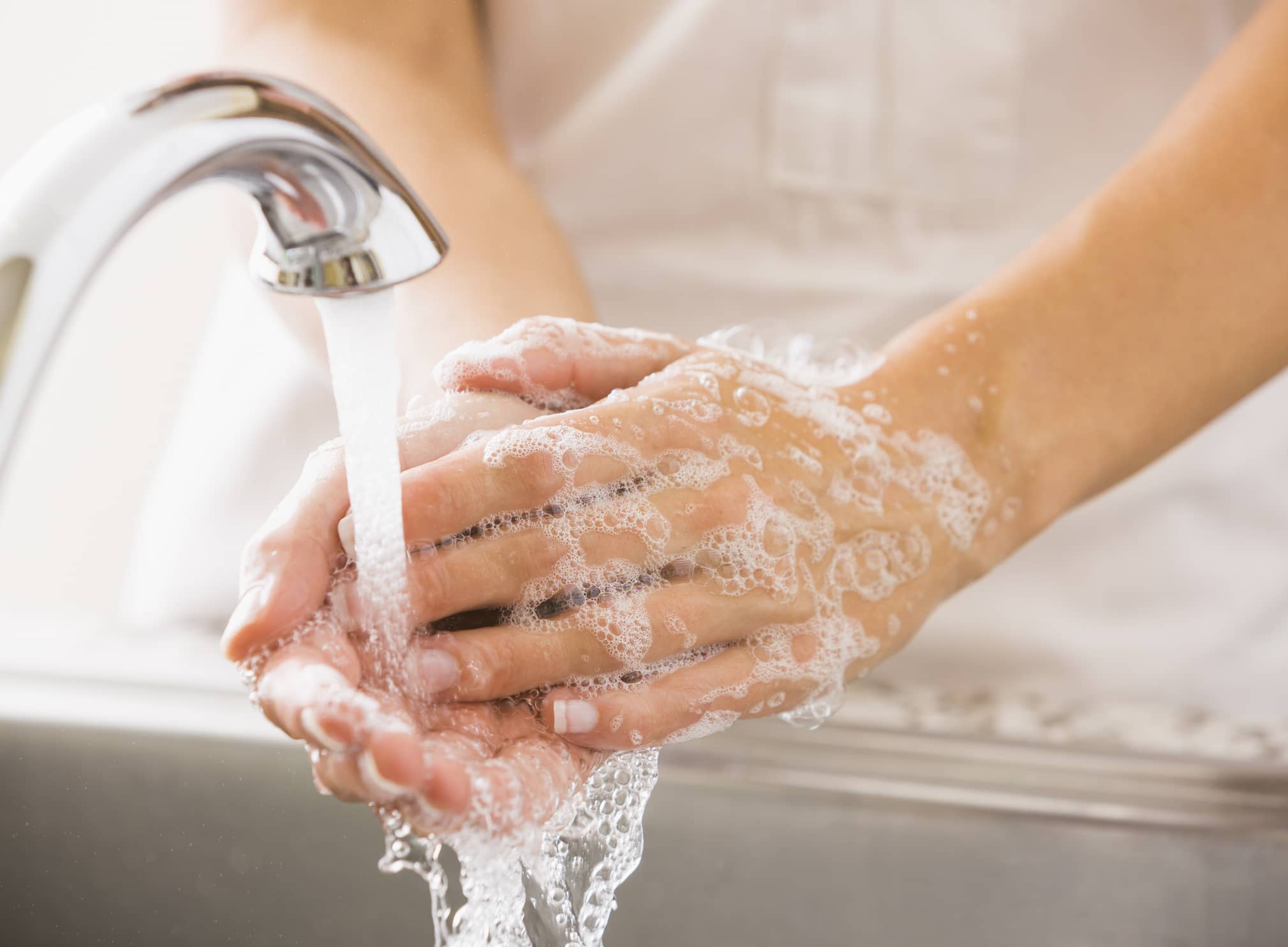 Soapy Hands Under Running Water