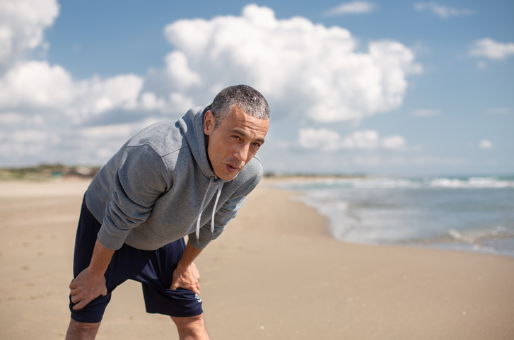 Man on Beach Breathing Hard