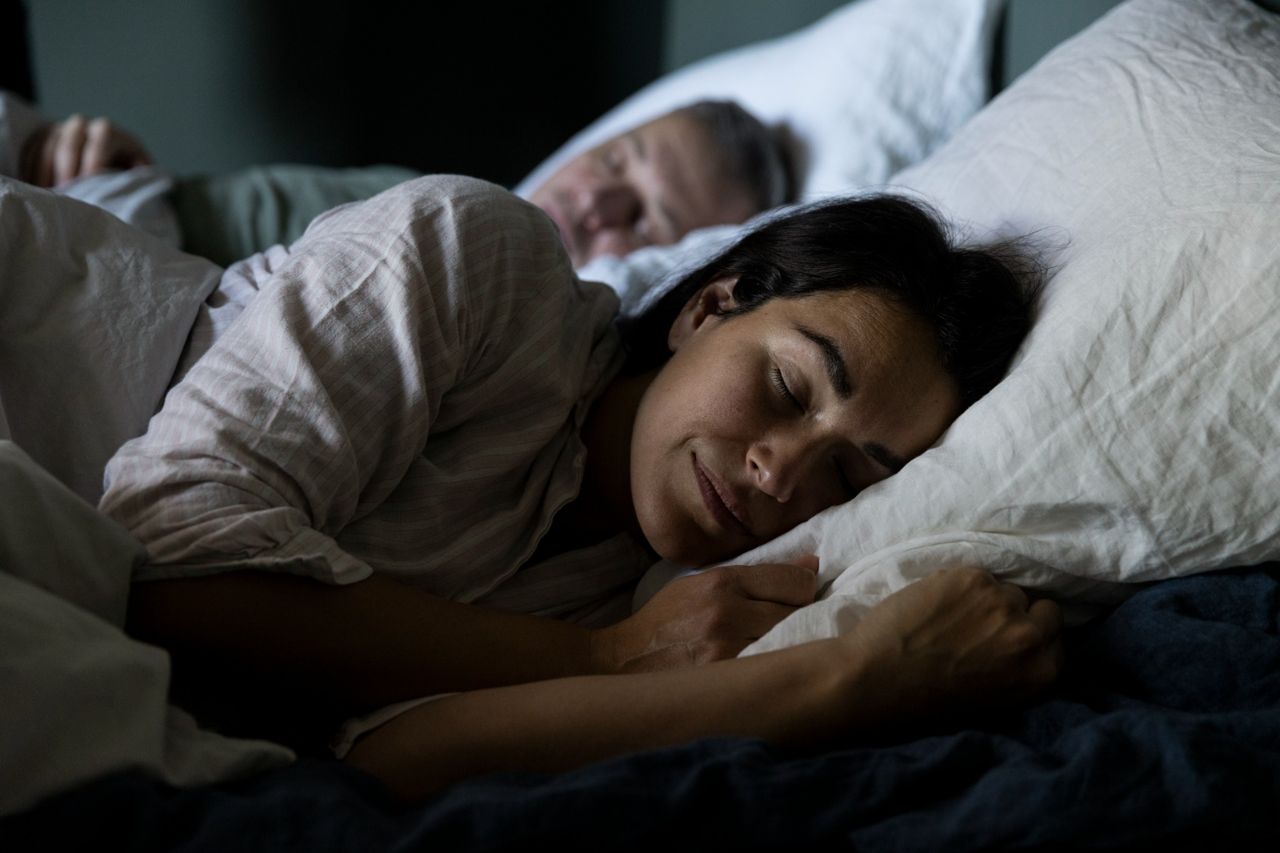 Couple sleeping peacefully in bed