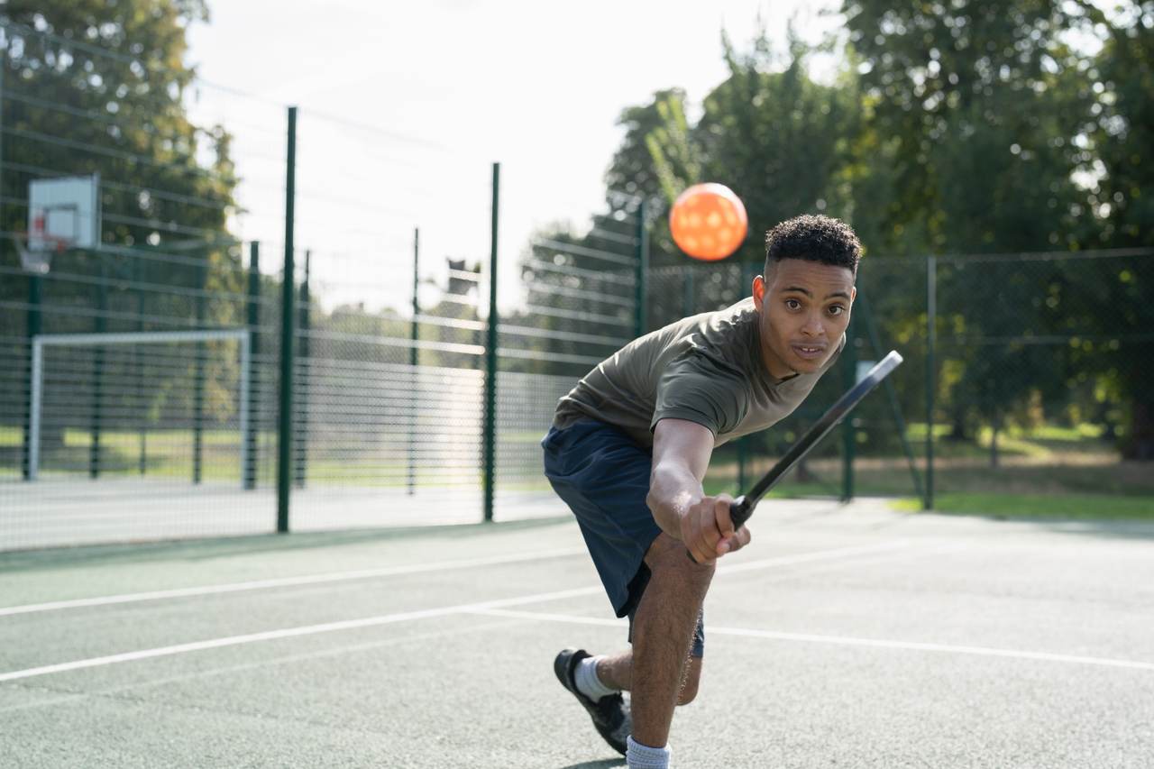 Man leaning forward playing pickleball