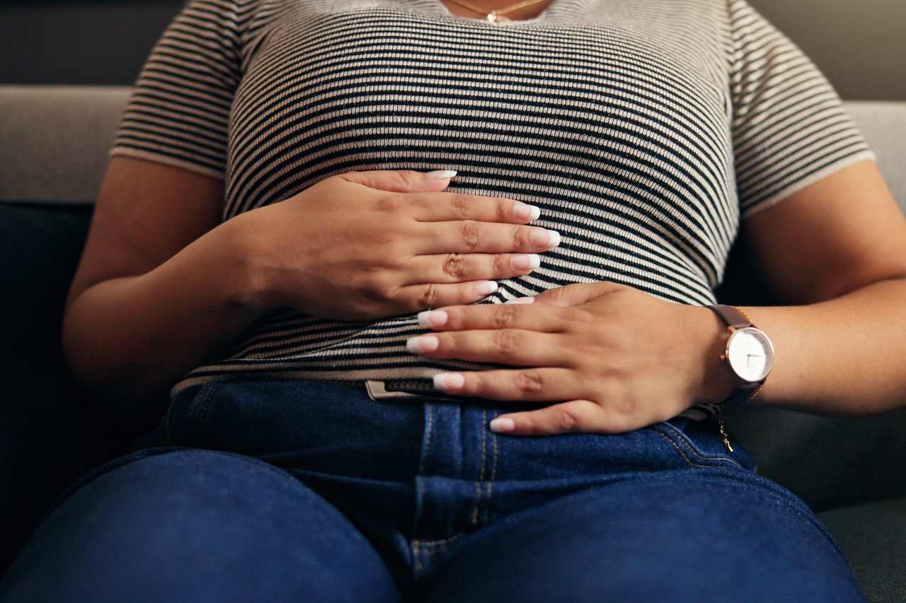 Woman with hands on her stomach