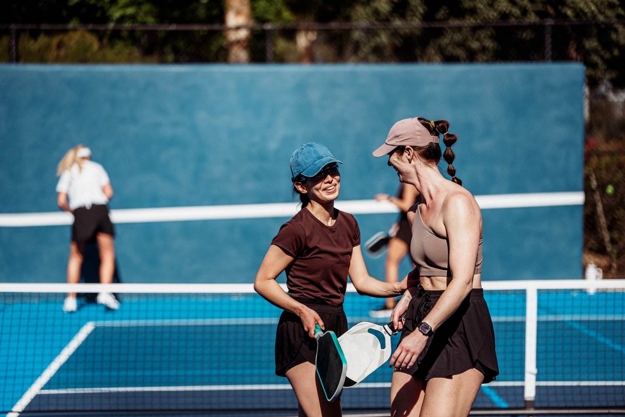 Two women playing pickleball