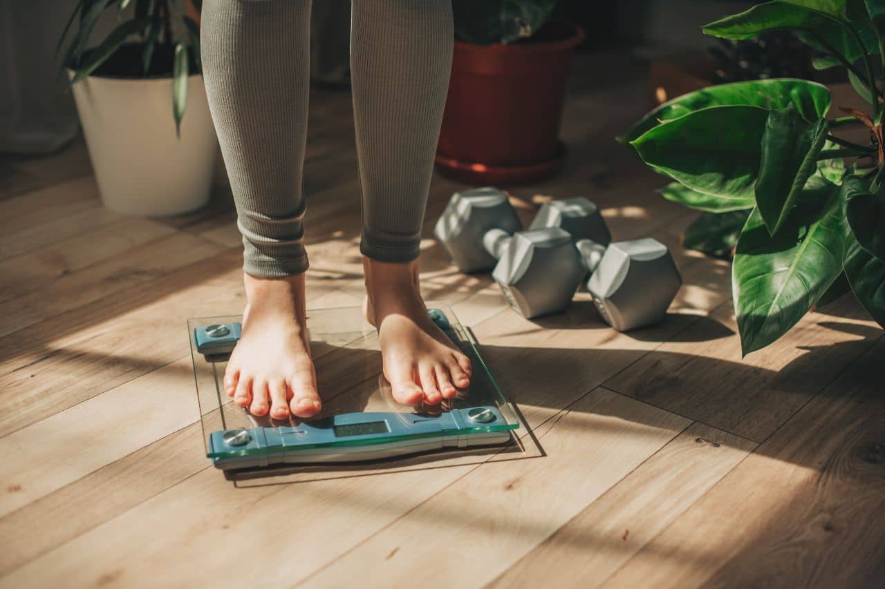 Woman standing on a glass scale