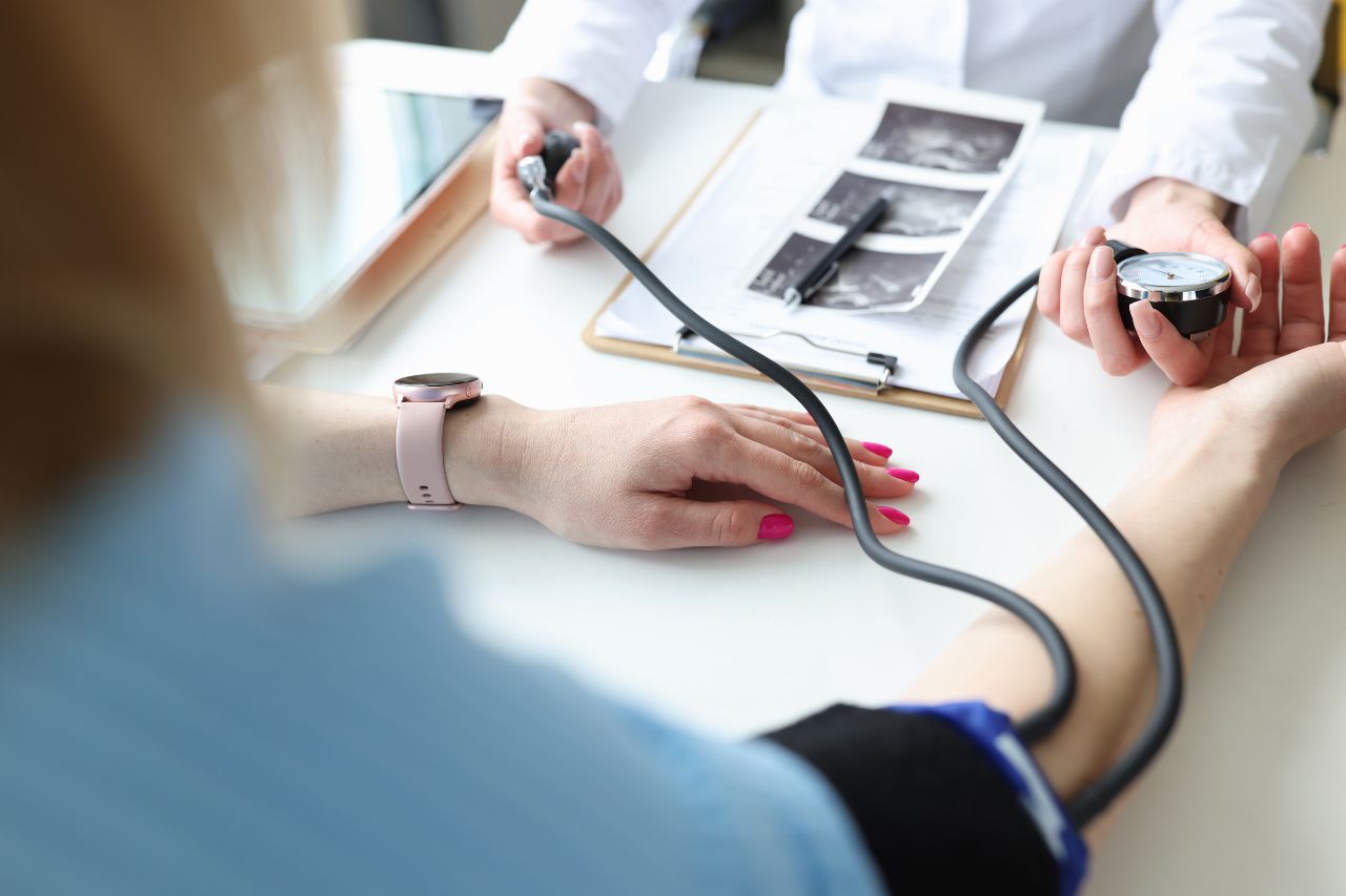 woman taking blood pressure for eclampsia