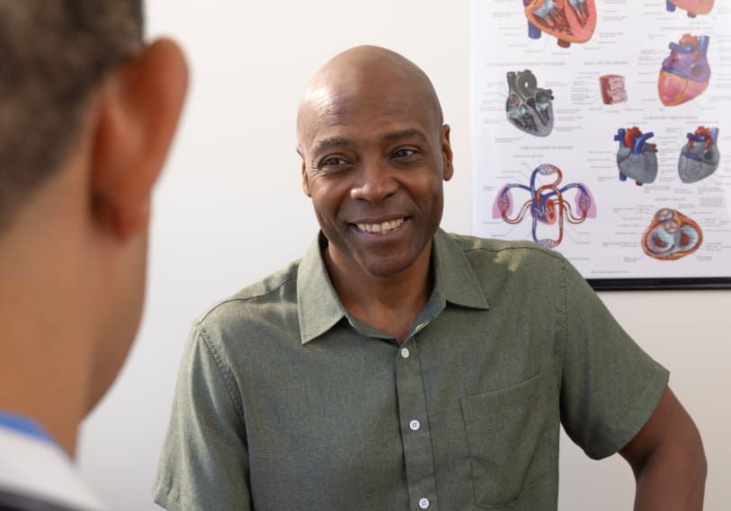 Man smiling while talking to doctor