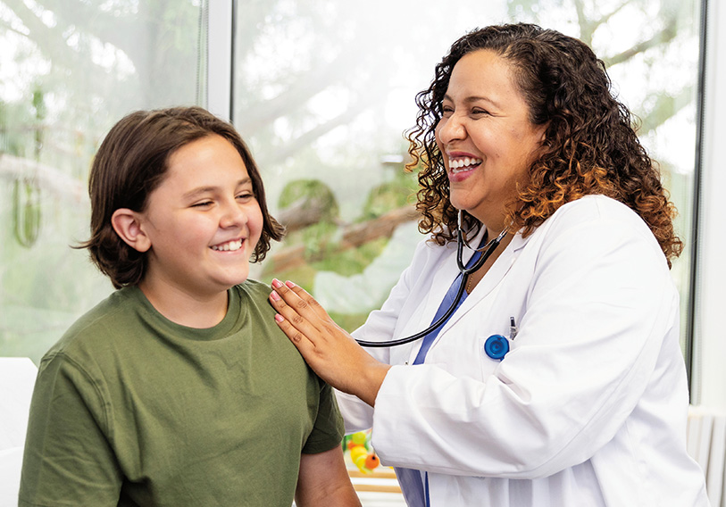 Smiling Physician and Young Teen in Office