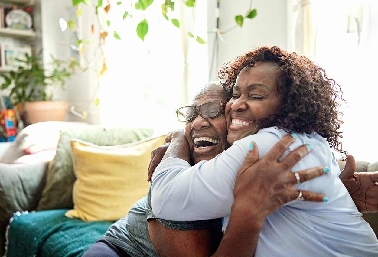 Two people hugging each other