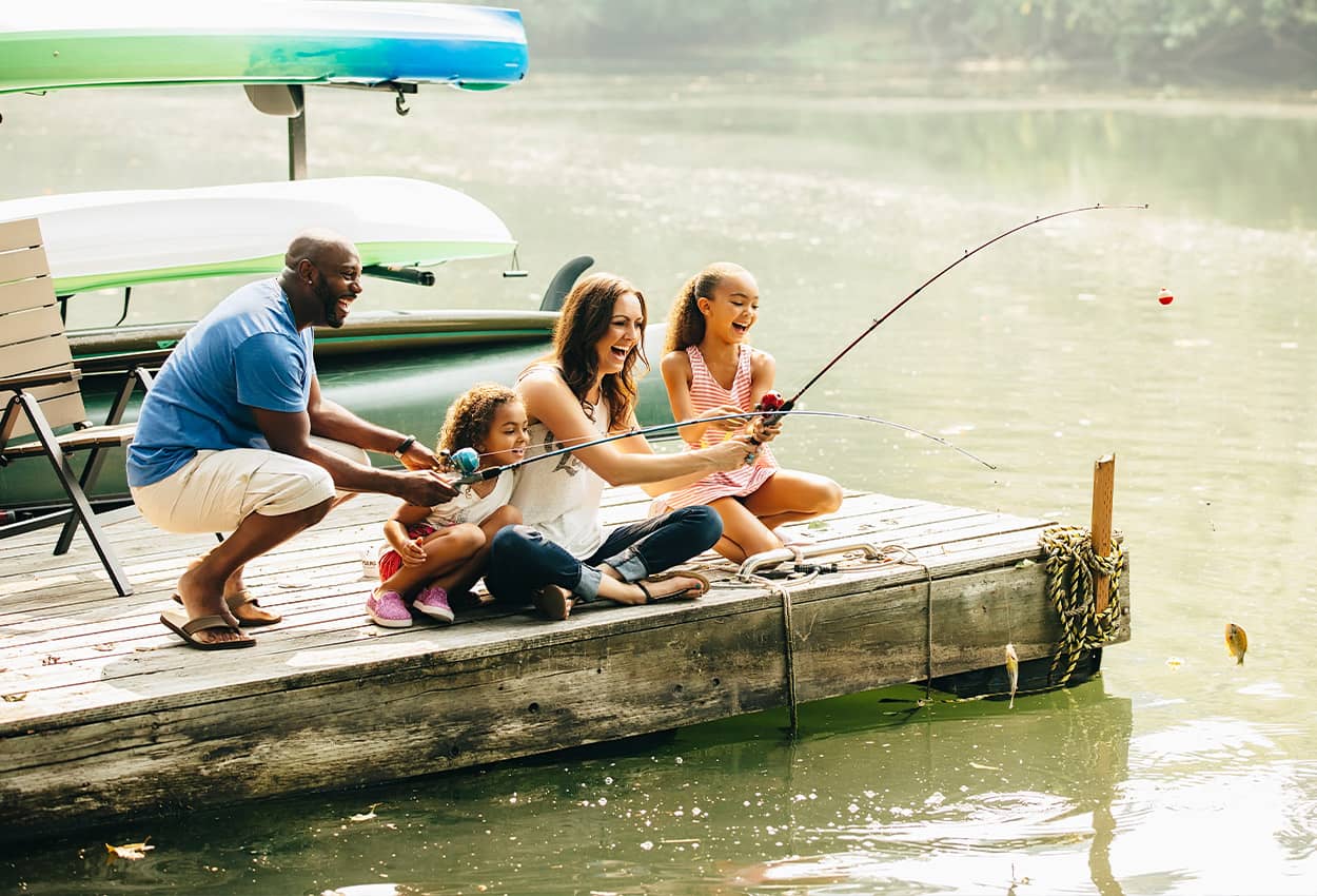 A family fishing off a dock