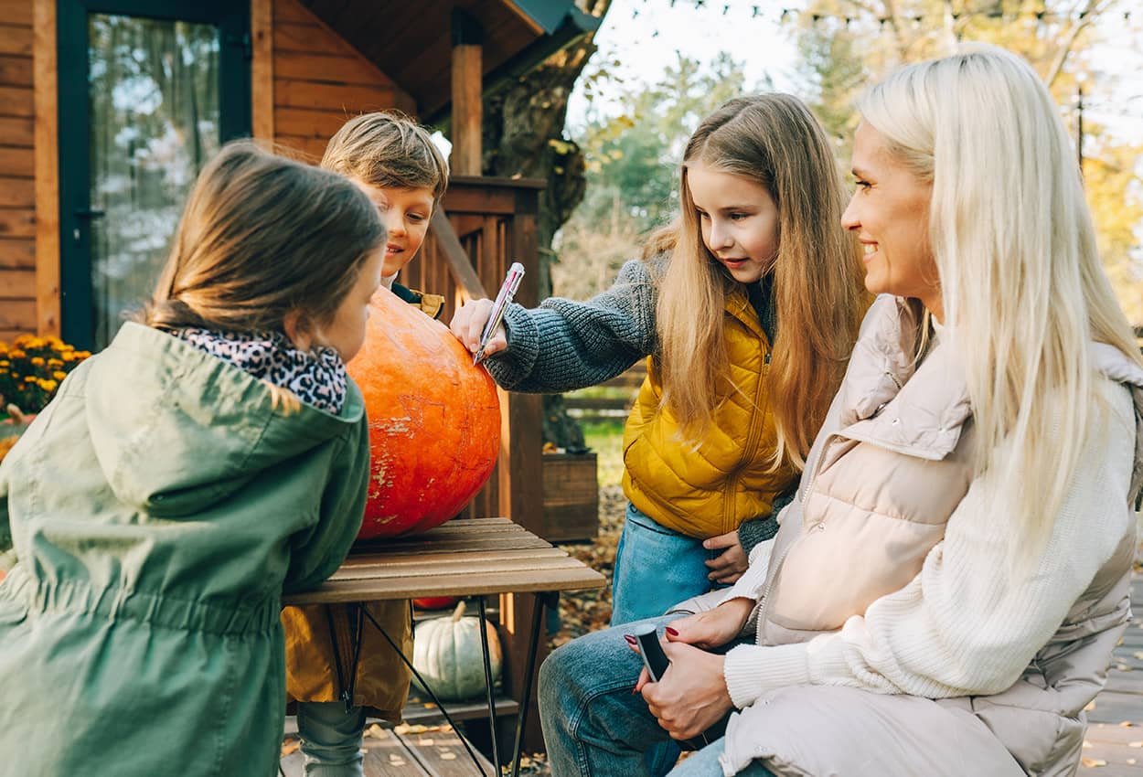 Family carving a pumpkin