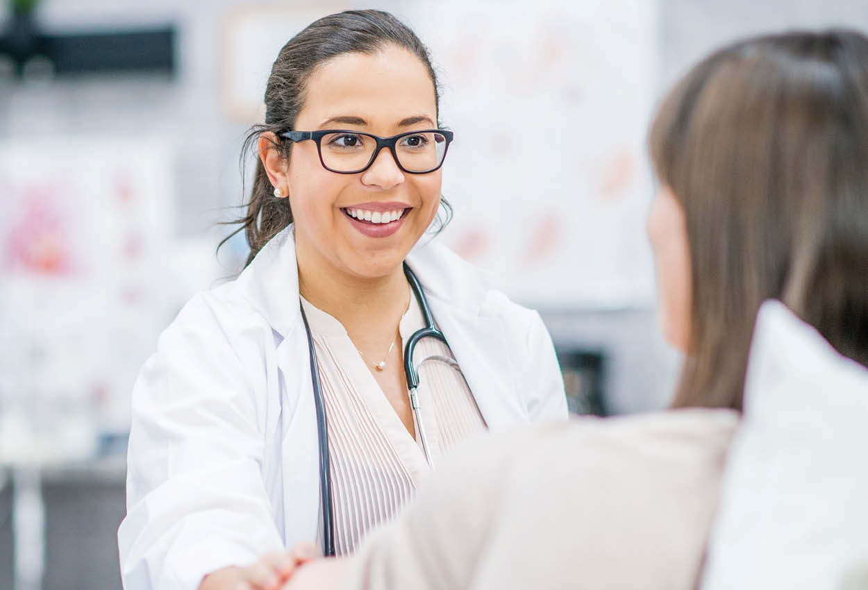 Smiling doctor seeing patient
