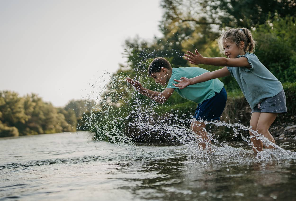 Kids playing next to a creek