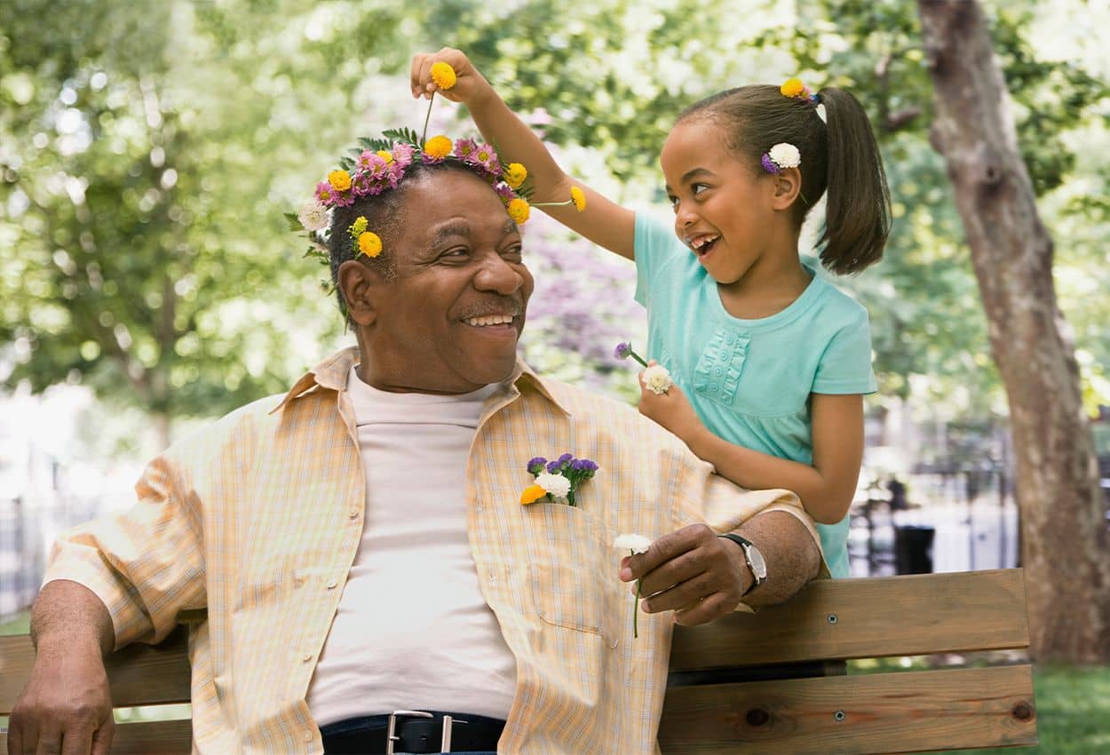 grandfather and granddaughter with flowers