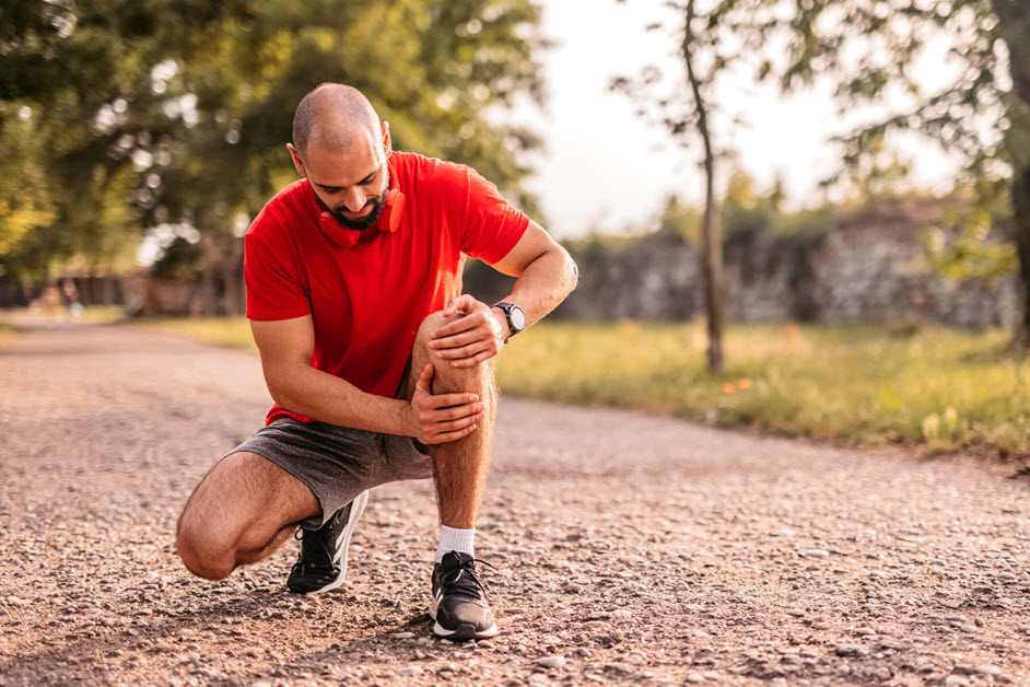 Man holding knee