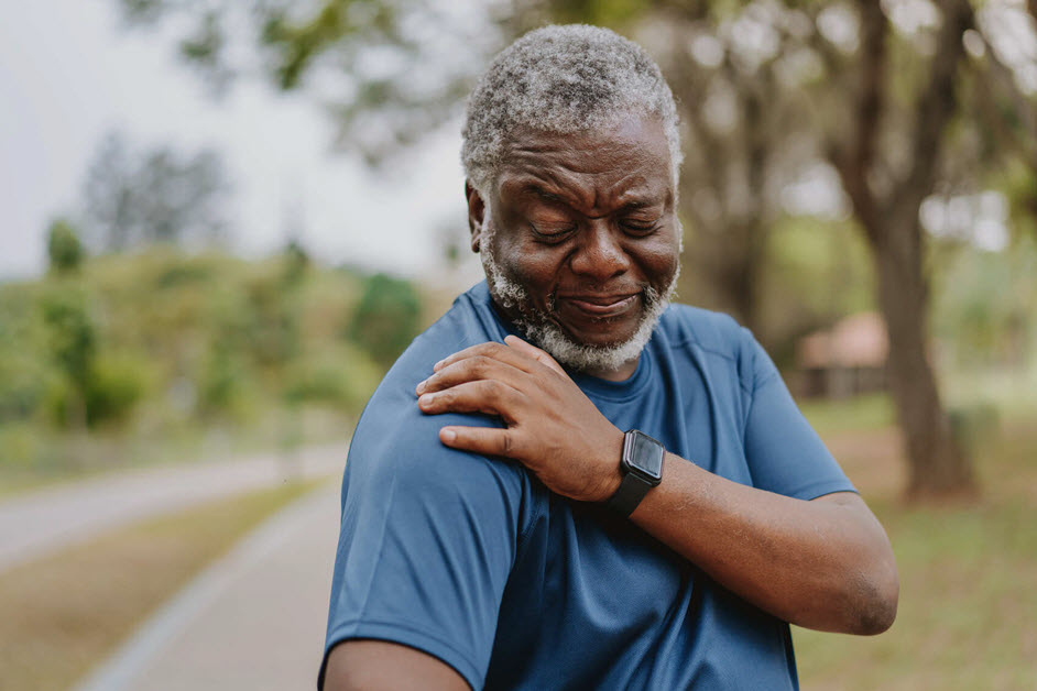 Man holding shoulder