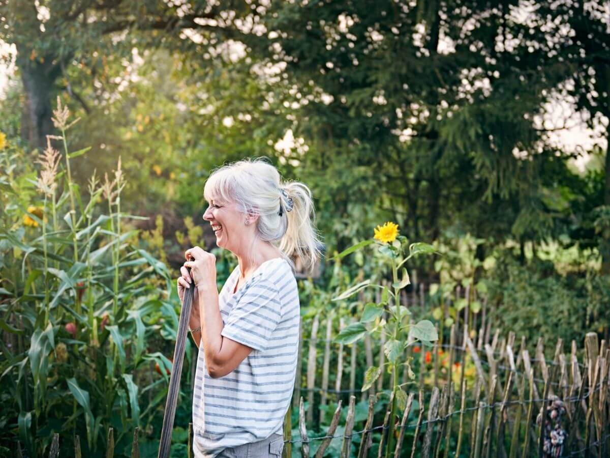 Middle aged woman working in her backyard garden