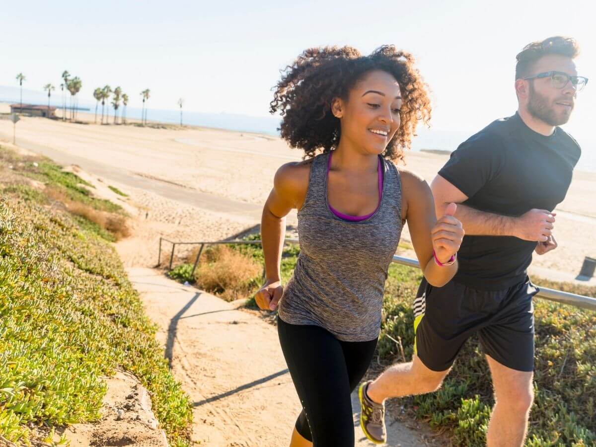 man and woman running together outside