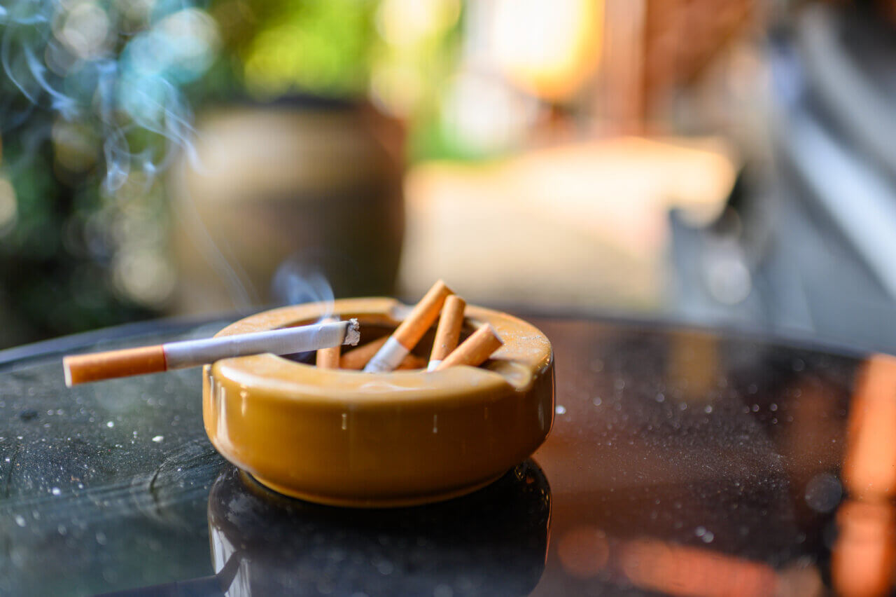 secondhand smoke from cigarette in ashtray