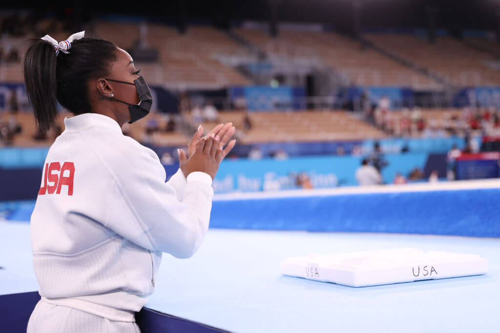 Simone Biles cheers for her teammates during the Women's Team Final on day four of the Tokyo 2020 Olympic Games at Ariake Gymnastics Centre on July 27, 2021 in Tokyo, Japan. (Photo by Laurence Griffiths/Getty Images)