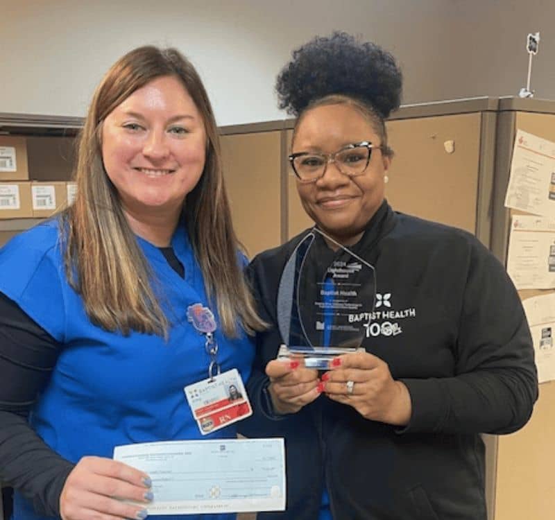 Amy Osbron and Joyce Woods proudly display the check and award from Lighthouse Awards Grants Program.