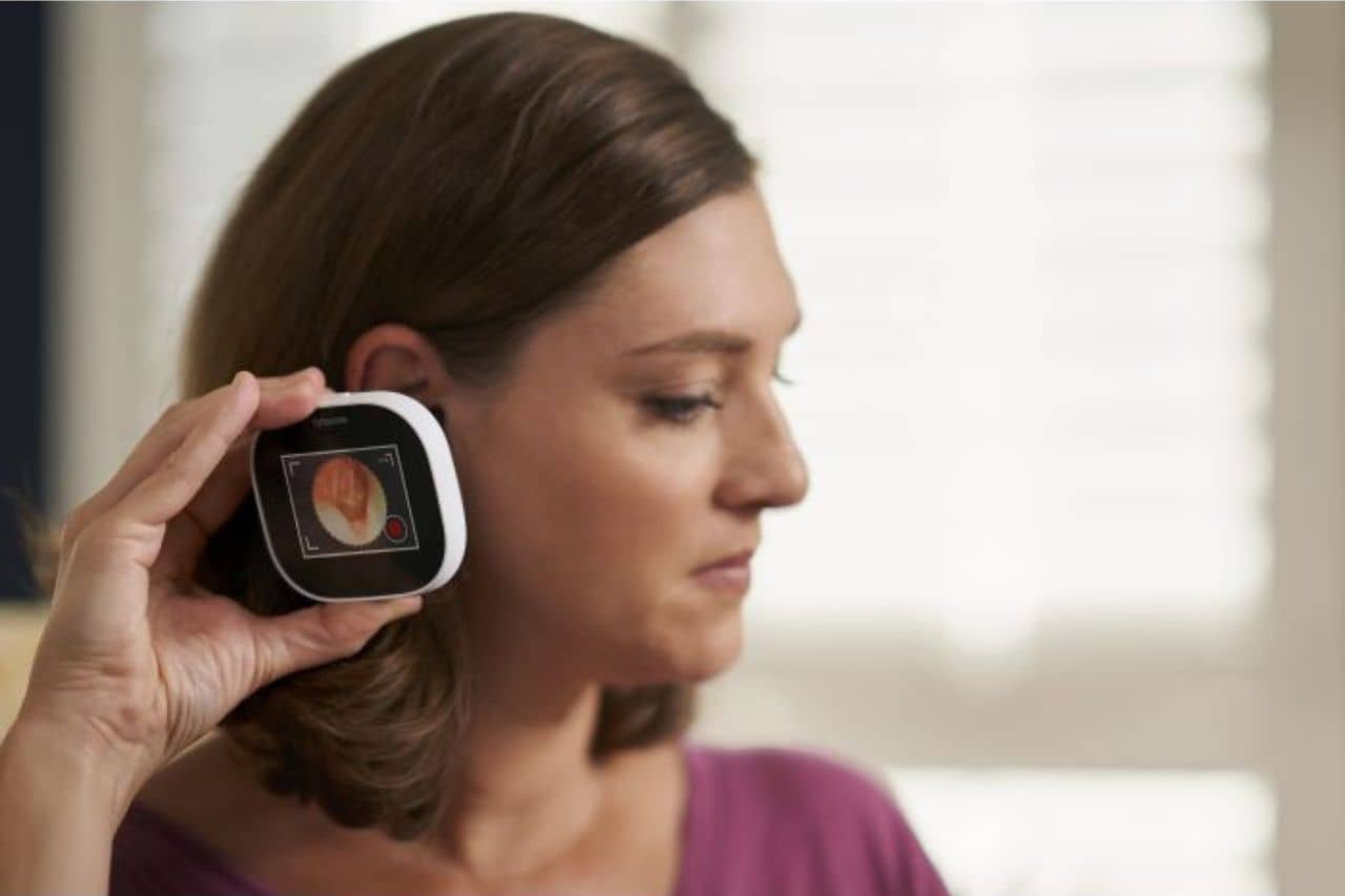 Woman with a device to her ear